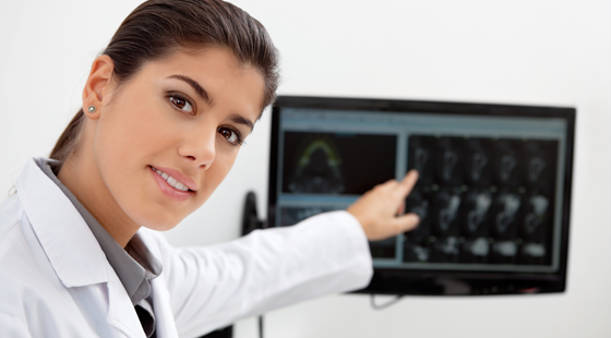 a dentist pointing at the screen with teeth digital images
