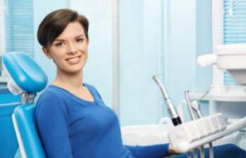 A woman sitting in a dental chair.