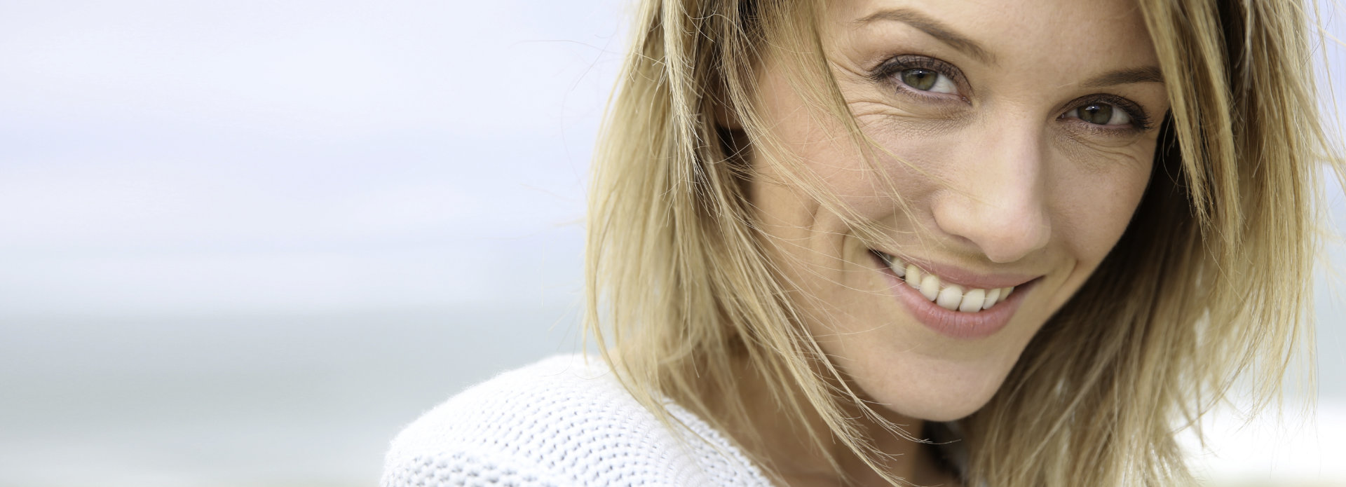 happy woman showing her teeth in a beautiful smile after root canal treatment