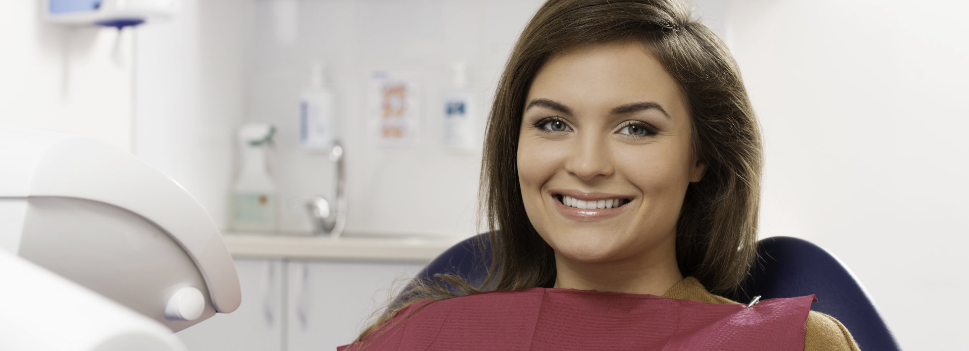 young woman with a beautiful smile in a dental chair