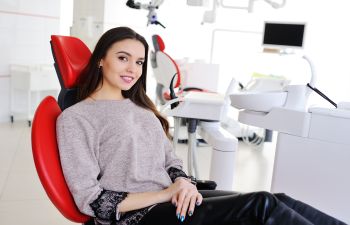 A woman sitting in a dentist's chair.