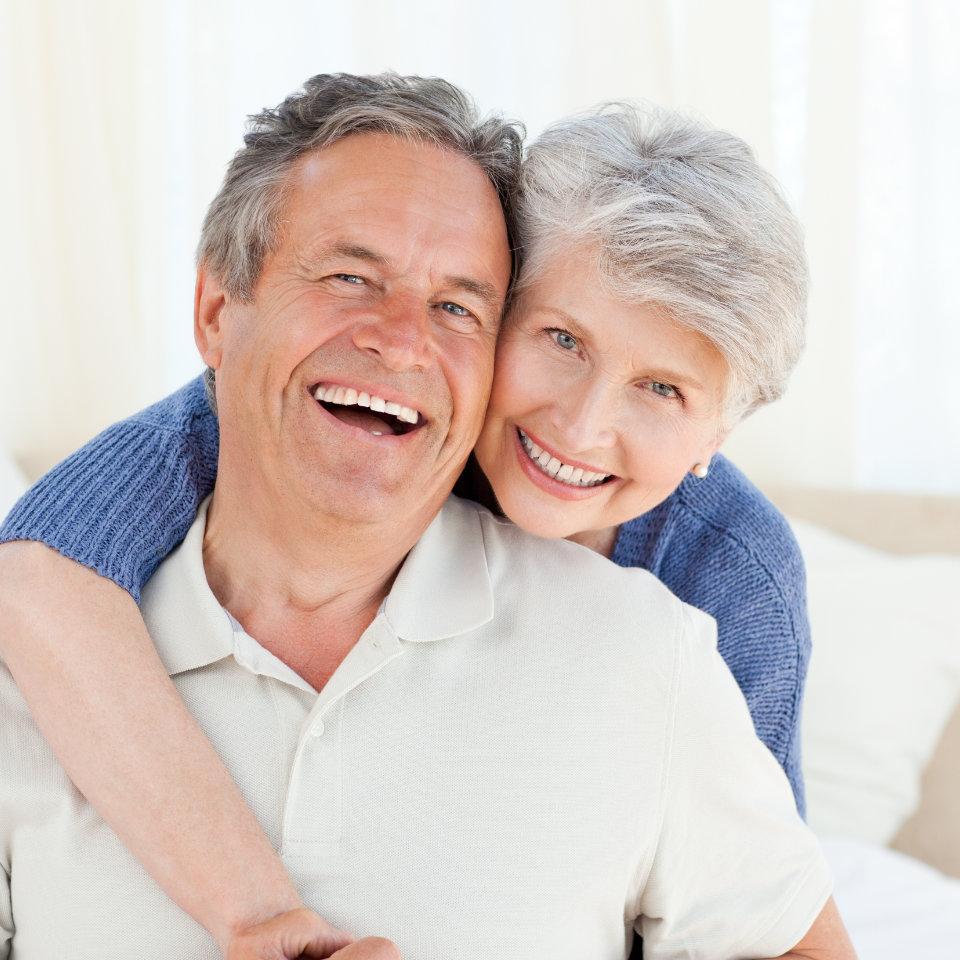 a broadly smiling senior couple