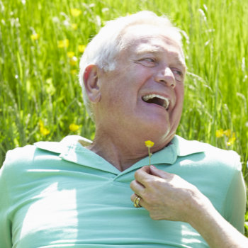 happy Senior couple Relaxing on a meadow In Summer