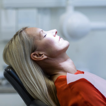 Relaxed woman patient under dental sedation