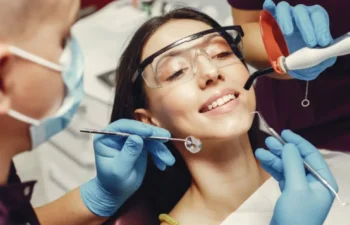 Dentist checking patient smile with mirror during clinic visit