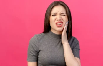 Woman with tooth pain after teeth whitening and tooth sensitivity issue