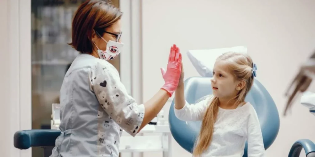 Pediatric Dentist in Acworth giving child a happy high five